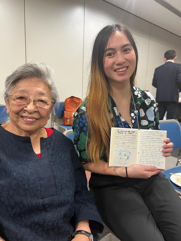 A person holding a book and smiling