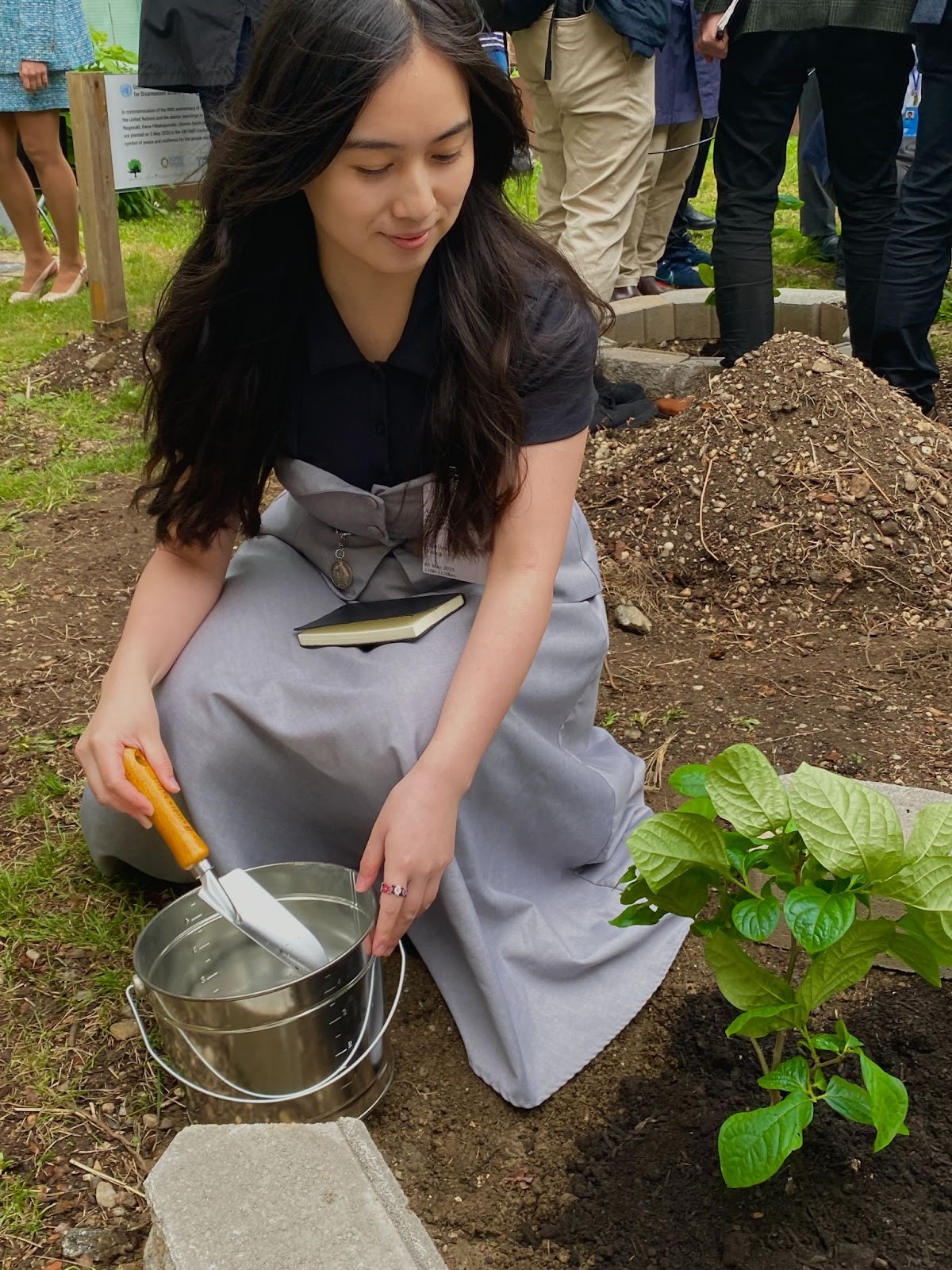 A person sitting on the ground with a bucket of water
AI-generated content may be incorrect., Picture