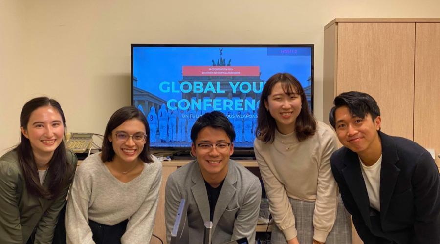 On the day of the conference, the author (far left) poses with its youth organizers.